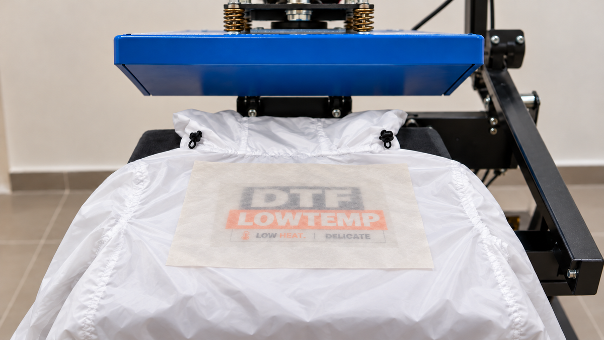Protective cover sheet placed over a DTF print for the final press
